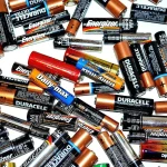 Discarded AA and AAA household batteries from brands like Duracell, Energizer, and Panasonic ready for eco-friendly disposal