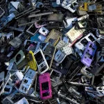 Bulk old mobile phones and smartphone scrap collected for e-waste recycling